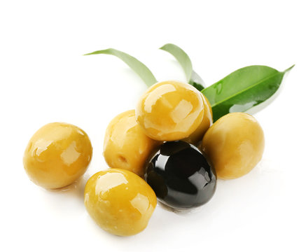 Green and black olives with leaves isolated on white
