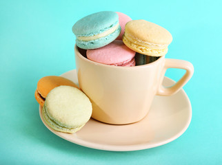 Assortment of gentle colorful macaroons in colorful mug