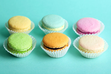 Set of gentle colorful macaroons on color background