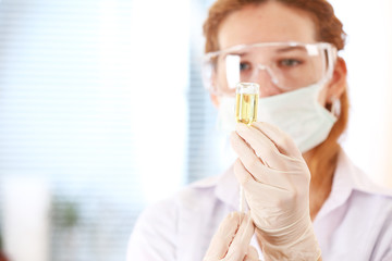 Doctor with medical syringe in hands, getting ready for