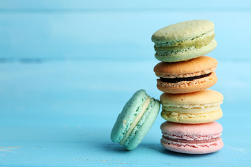 Gentle colorful macaroons on color wooden background