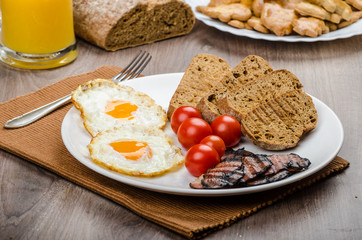 Breakfast- bacon, sausage, bread and eggs