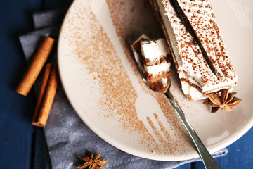 Tasty tiramisu cake on plate, close up