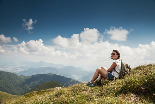 Woman highhiking have a time for rest on the mountain hill
