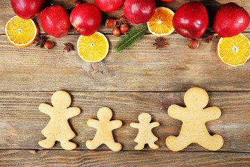 Christmas cookies and fruits on wooden table