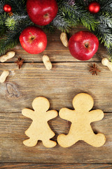 Christmas cookies and fruits on wooden table