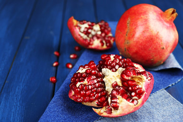 Juicy ripe pomegranates on wooden table
