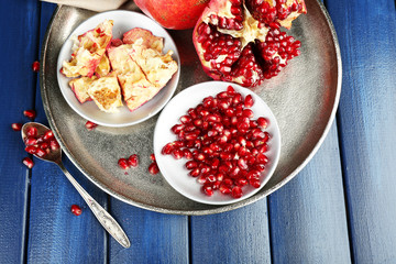 Juicy ripe pomegranates on wooden table
