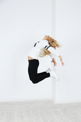 Hip hop dancer dancing on wall background