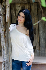 Fototapeta premium Beautiful woman front of wooden old house
