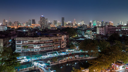 Naklejka na ściany i meble An aerial view of Bangkok city and old market along canal