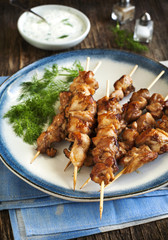 Barbecue chicken skewers with yogurt sauce.