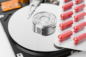 Pills on computer hard drive - concept technology background