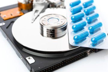 Pills on computer hard drive - concept technology background