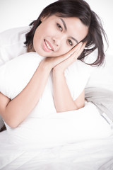 Portrait of a beautiful young woman in bed