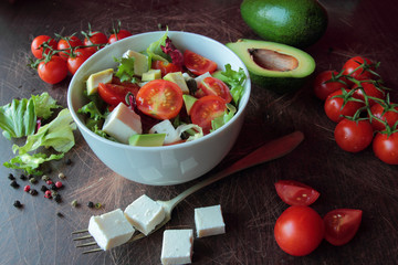 Fresh vegetable salad on a wooden table
