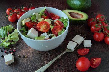 Vegetable sald in a bowl on wooden table