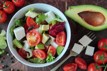 Vegetable salad with tomatoes avocado lettuce and feta cheese