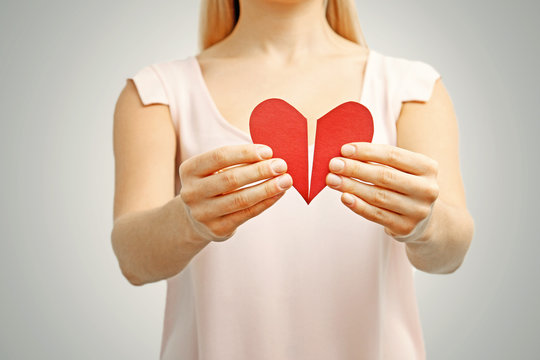 broken red heart in woman hands. concept of relationship, divorc