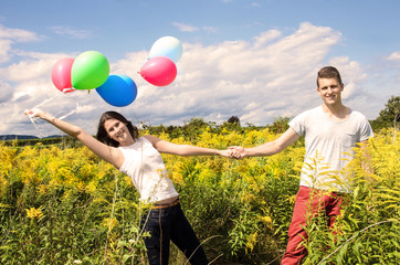 Happiness: Young couple with colorful balloons :)