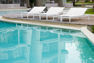 Swimming pool with beach chairs.