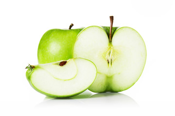 Green apples and apple slices isolated on white.