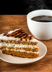piece cake on a plate and black coffee
