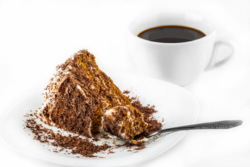 piece of chocolate cake on a plate and black coffee