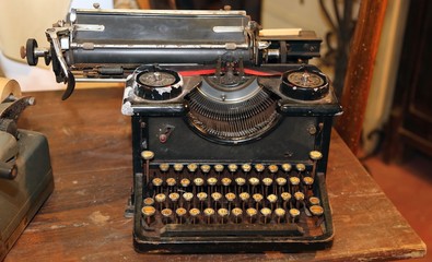 ancient black rusty typewriter with round  keys