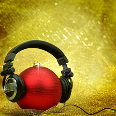 Naklejka na ściany i meble Christmas ball with headphones in glittering background