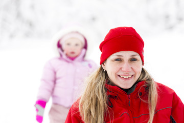 Fototapeta premium portrait of mother with little daughter in winter