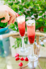 Summer cocktail with champagne and fresh raspberries