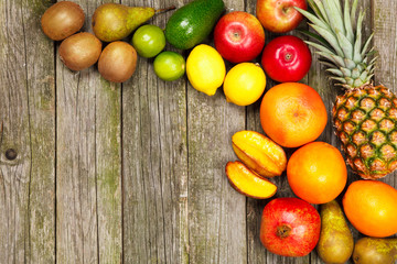 Set of colorful fruits on old wood background