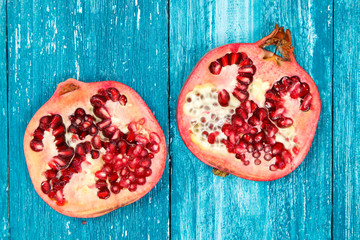 Fresh pomegranate on blue wood