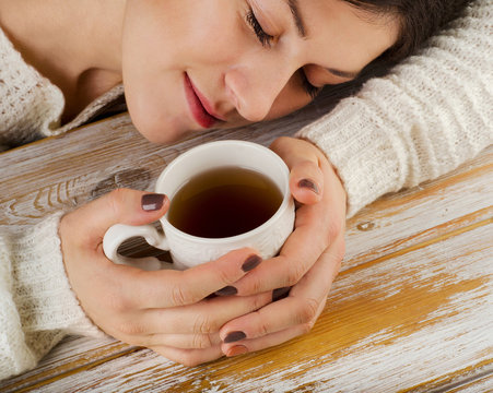 Relaxing young  girl with cup of tea