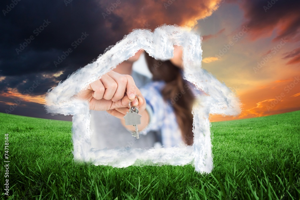 Poster man and wife presenting a key with a house keychain
