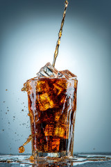 Cola pouring in a glass