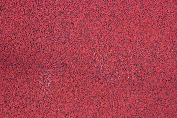 Red rubber running track as a background in the full frame, photography