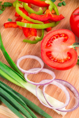 Close up of vegetables on wooden platter.