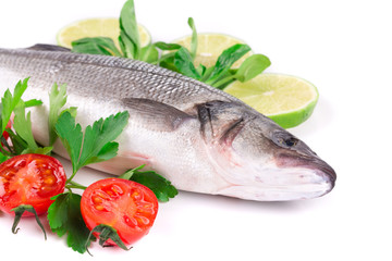 Fresh seabass with lemon ant tomatoe on plate.