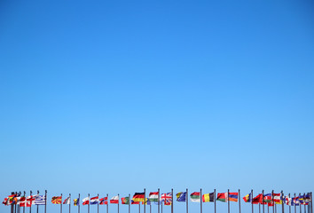 international flags against the sky - obrazy, fototapety, plakaty