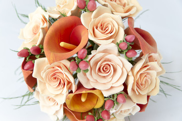 Colorful bouquet of orange calla lilies on a white background
