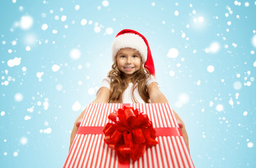 Child holding Christmas gift box in hand. Isolated on background