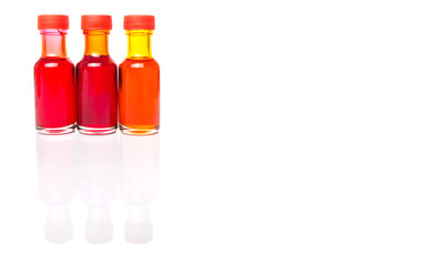 Liquid orange food color additive over white background 