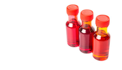 Liquid orange food color additive over white background 