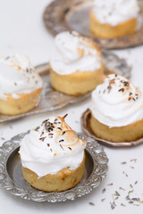 Obraz na płótnie Canvas delicious cupcakes with white cream and lavender tea