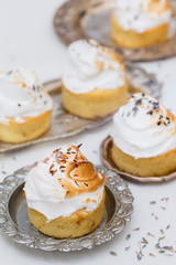 delicious cupcakes with white cream and lavender tea