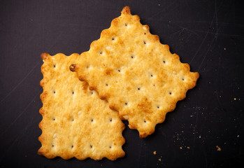 cookies crackers and crumbs on a dark background