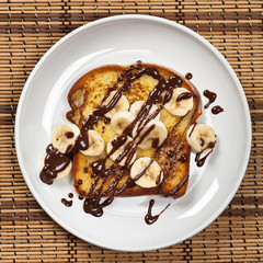 French Toast with Bananas and Chocolate sauce. Selective focus