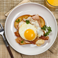 Sandwich with fried eggs - Croque Madame. Selective focus.